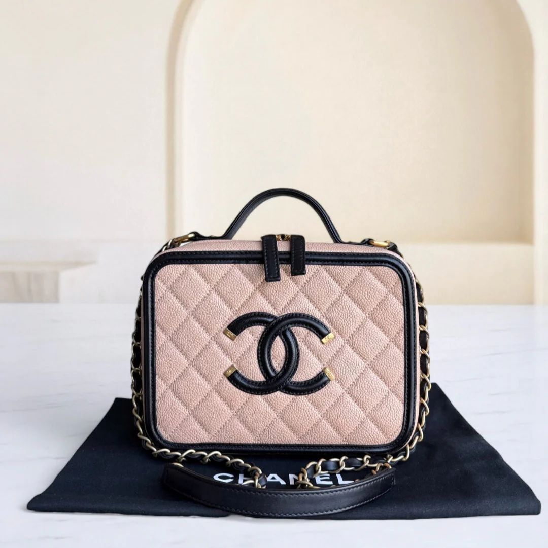 Chanel handbag with beige quilted leather and black accents on a white surface.