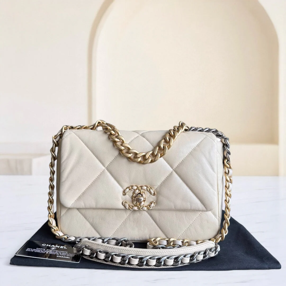 White quilted handbag with gold chain strap on a white background