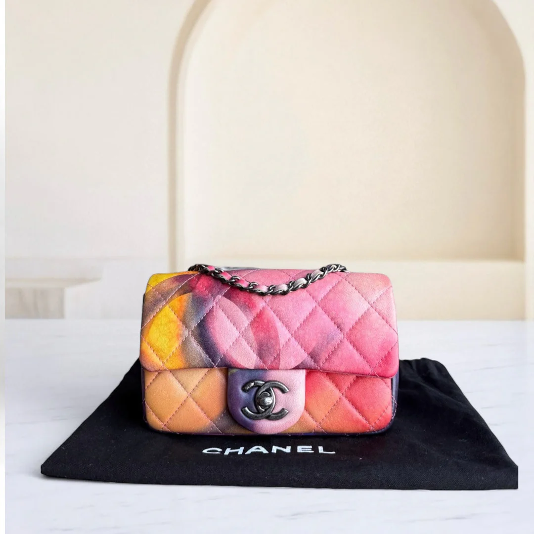 Multicolored Chanel handbag on a black cloth with a blurred background