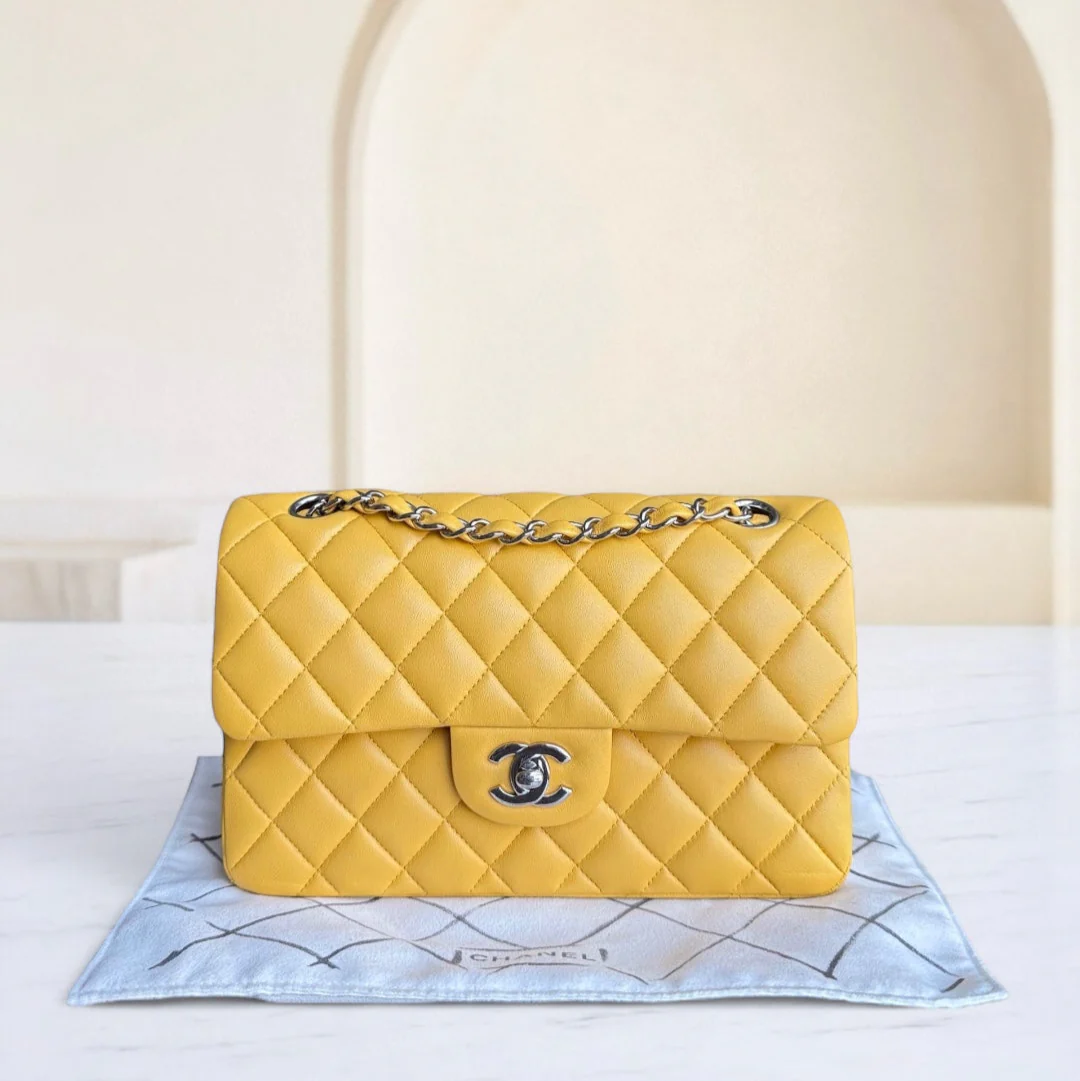 Yellow quilted handbag with Chanel logo on a light background
