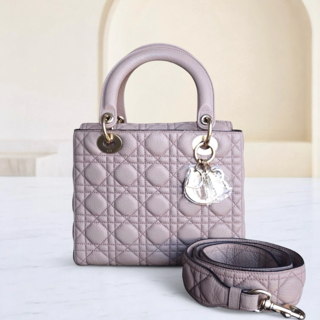 Quilted handbag with matching keychain and strap on a light background