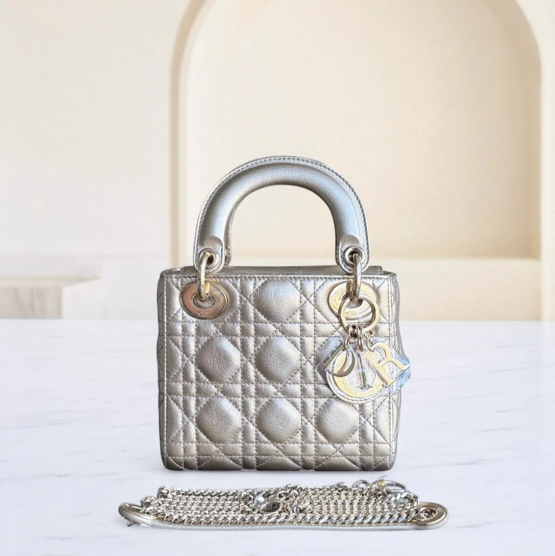 Silver handbag with chain detail on a white surface