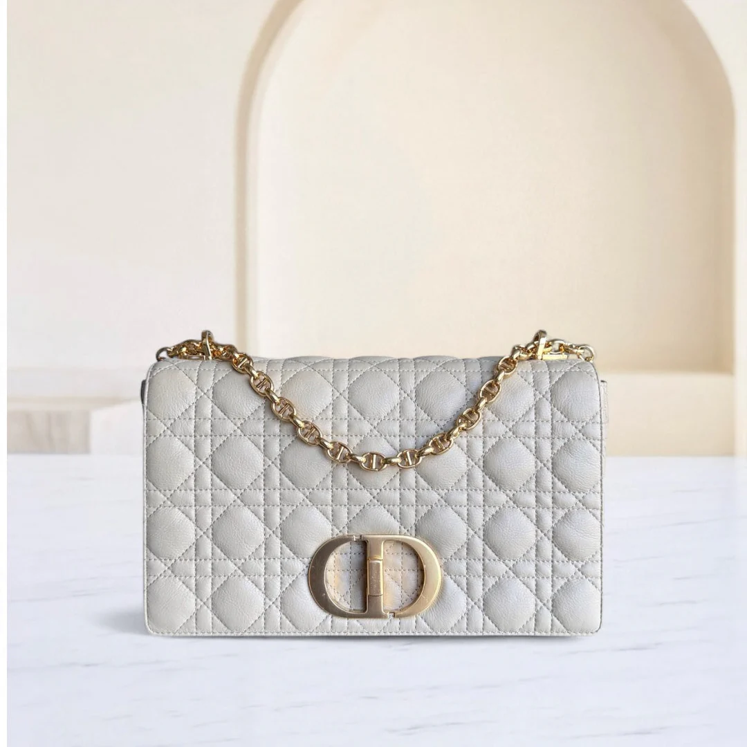 Quilted handbag with gold chain and clasp on a white background