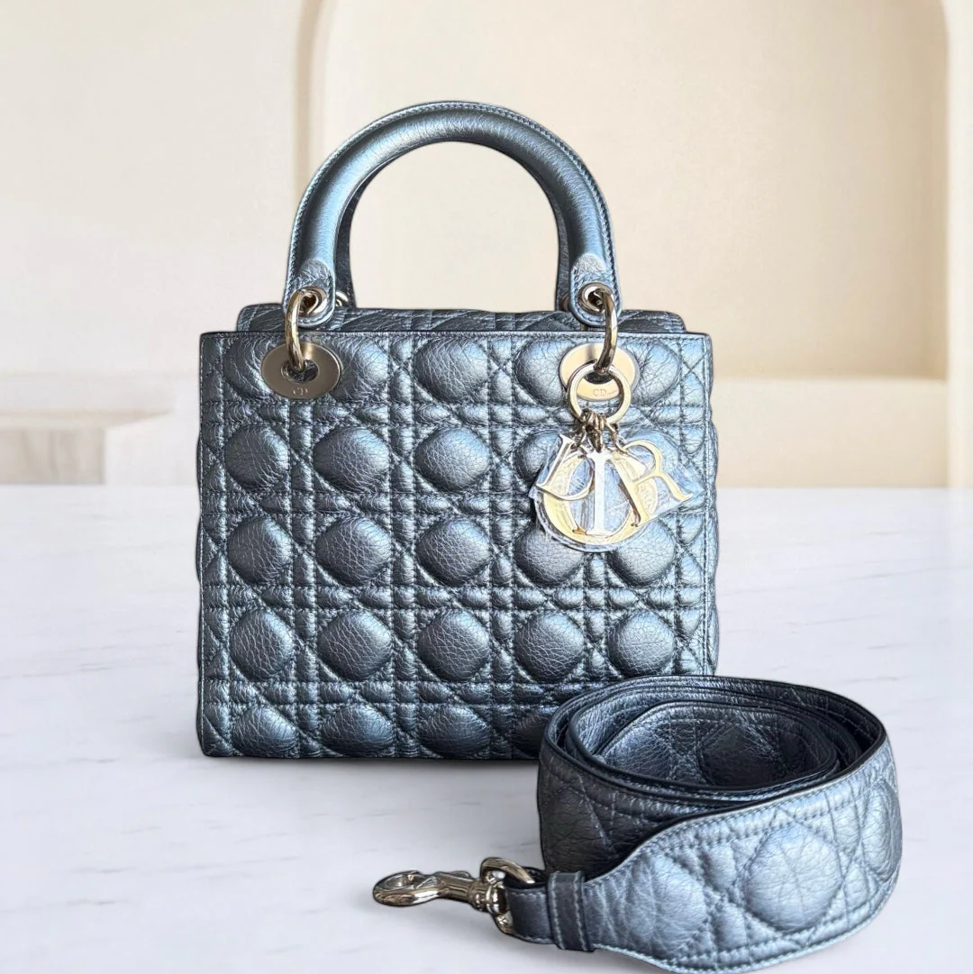Blue quilted handbag with gold hardware on a white surface