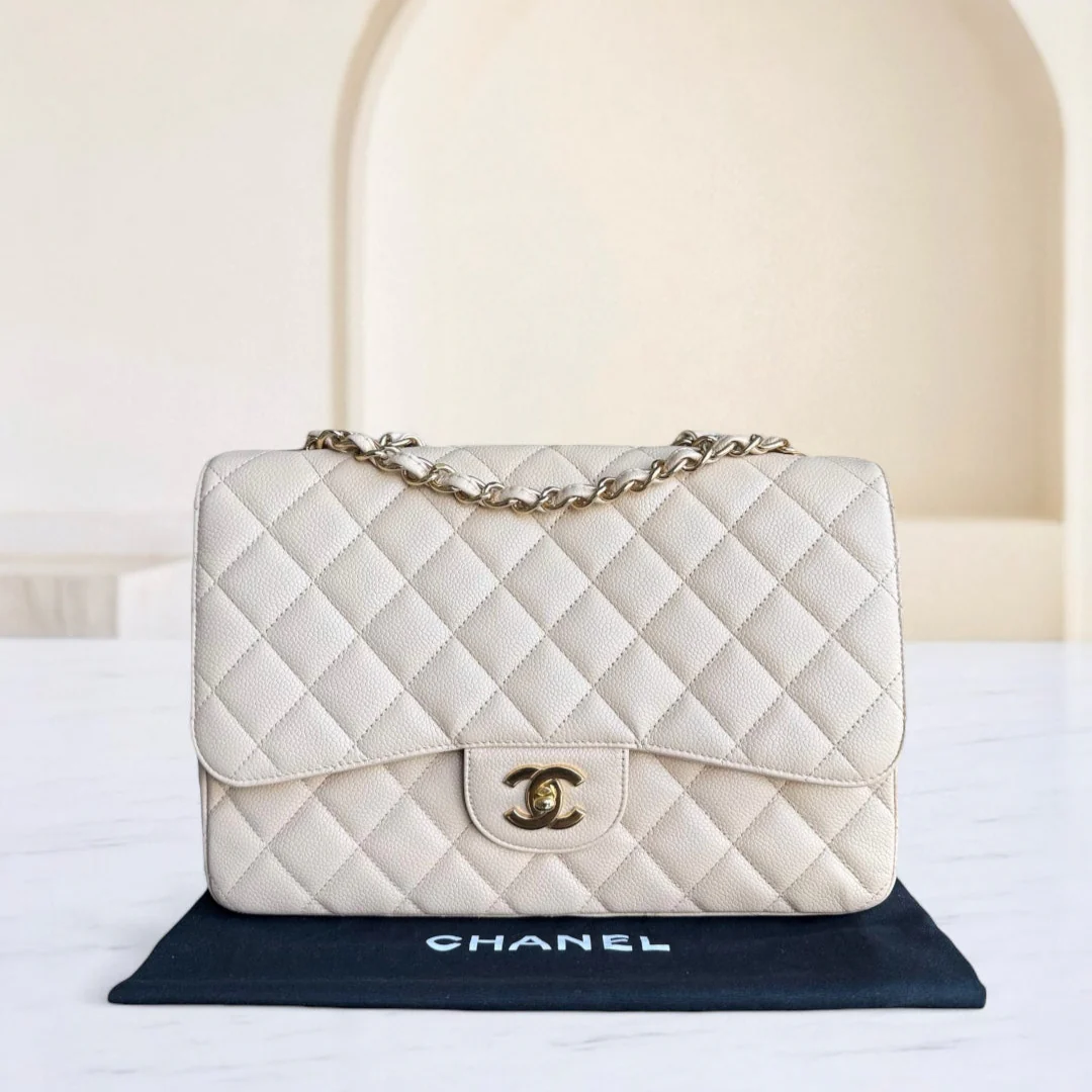 Quilted white Chanel handbag on a black stand with a white background