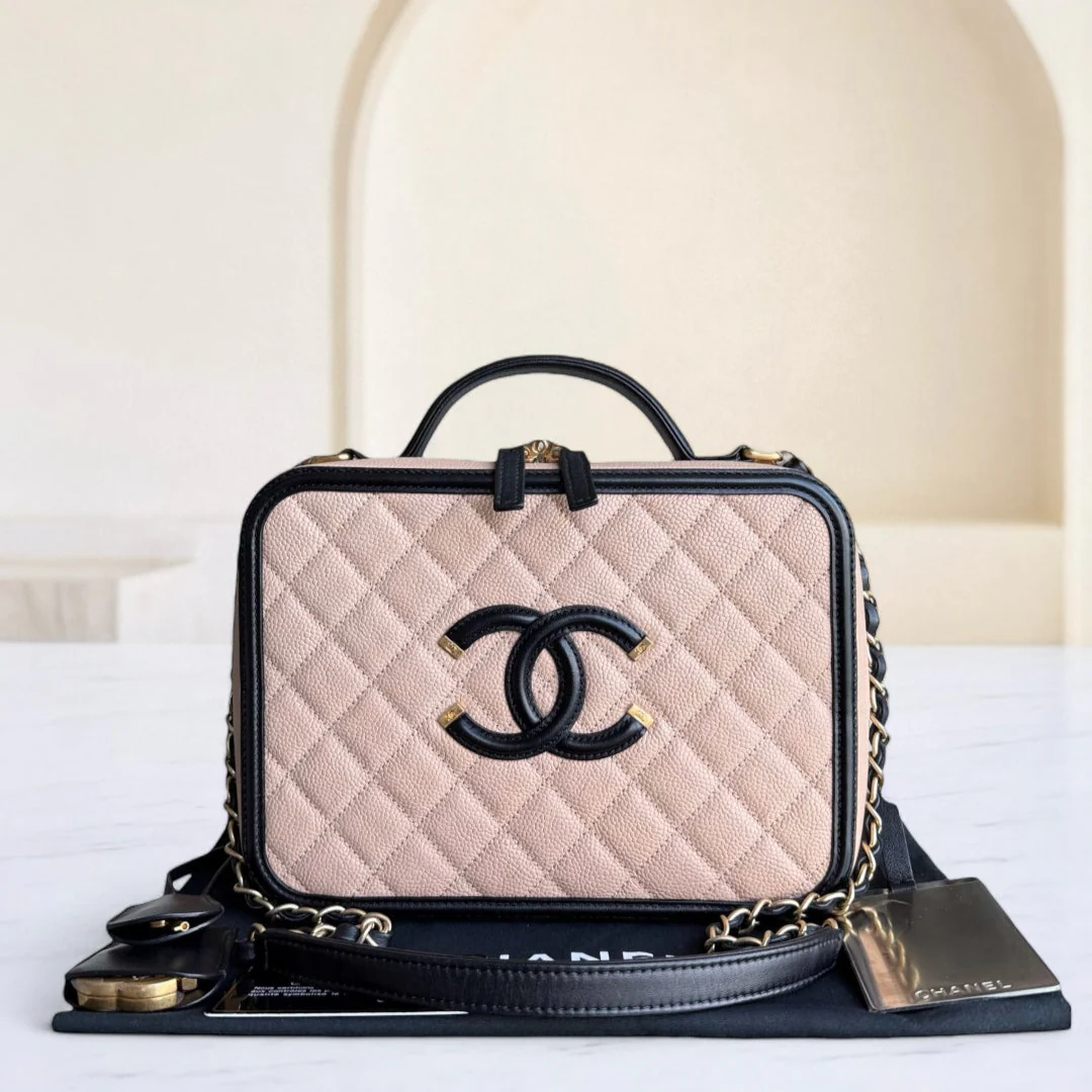 Chanel handbag with beige quilted leather and black accents on a white surface.