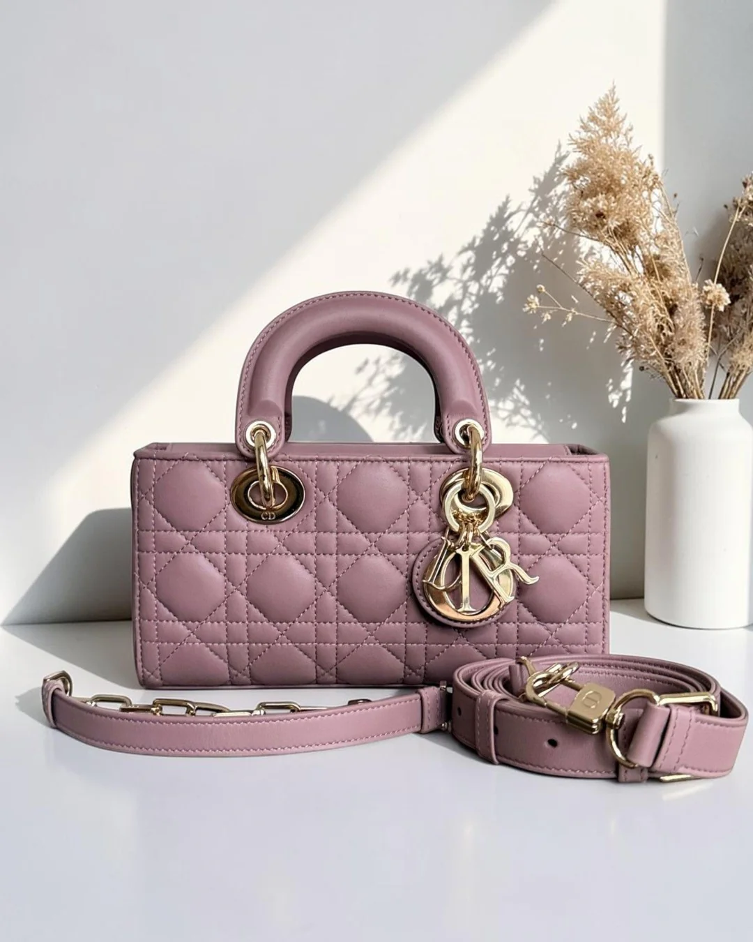 Best Luxury Designers pink lambskin Dior D-Joy small Lady bag with cannage stitching and gold hardware.