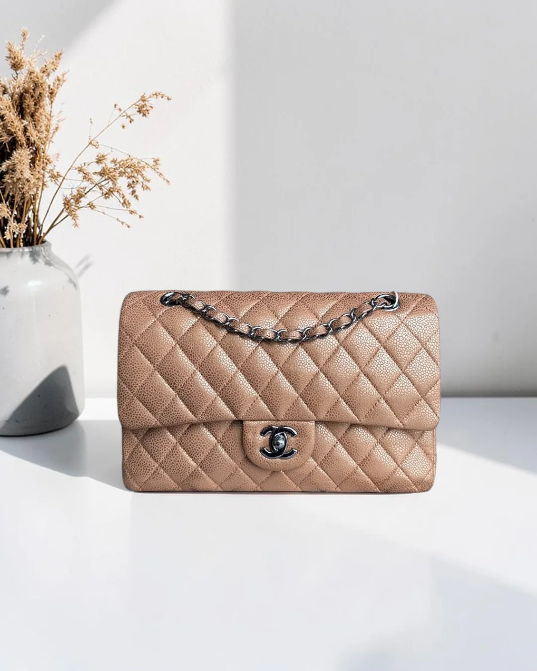Best Luxury Designers Chanel Classic Flap Medium quilted caviar leather handbag in beige with silver hardware and chain strap.